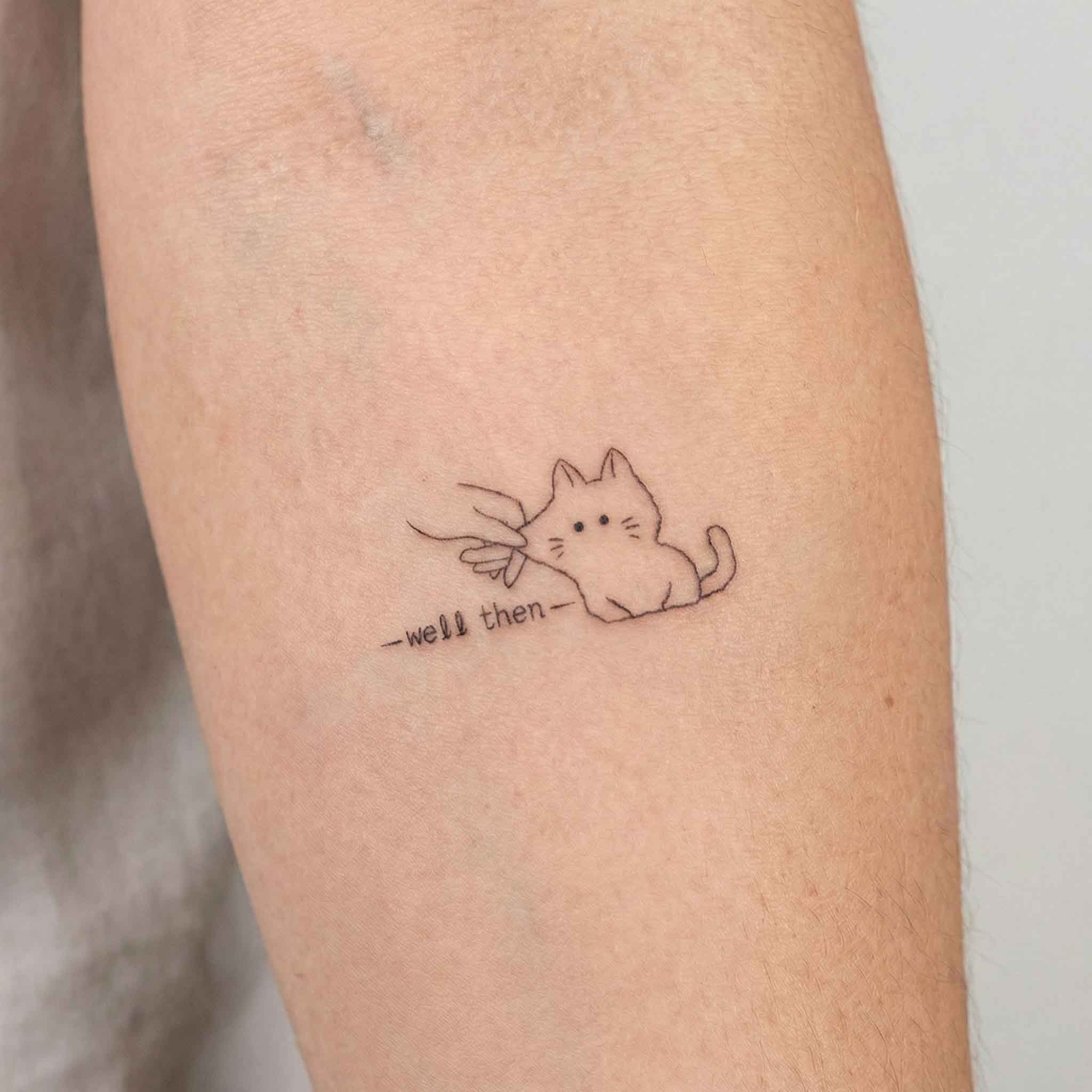 Funny cat tattoo worn on the wrist with simple handwritten wording