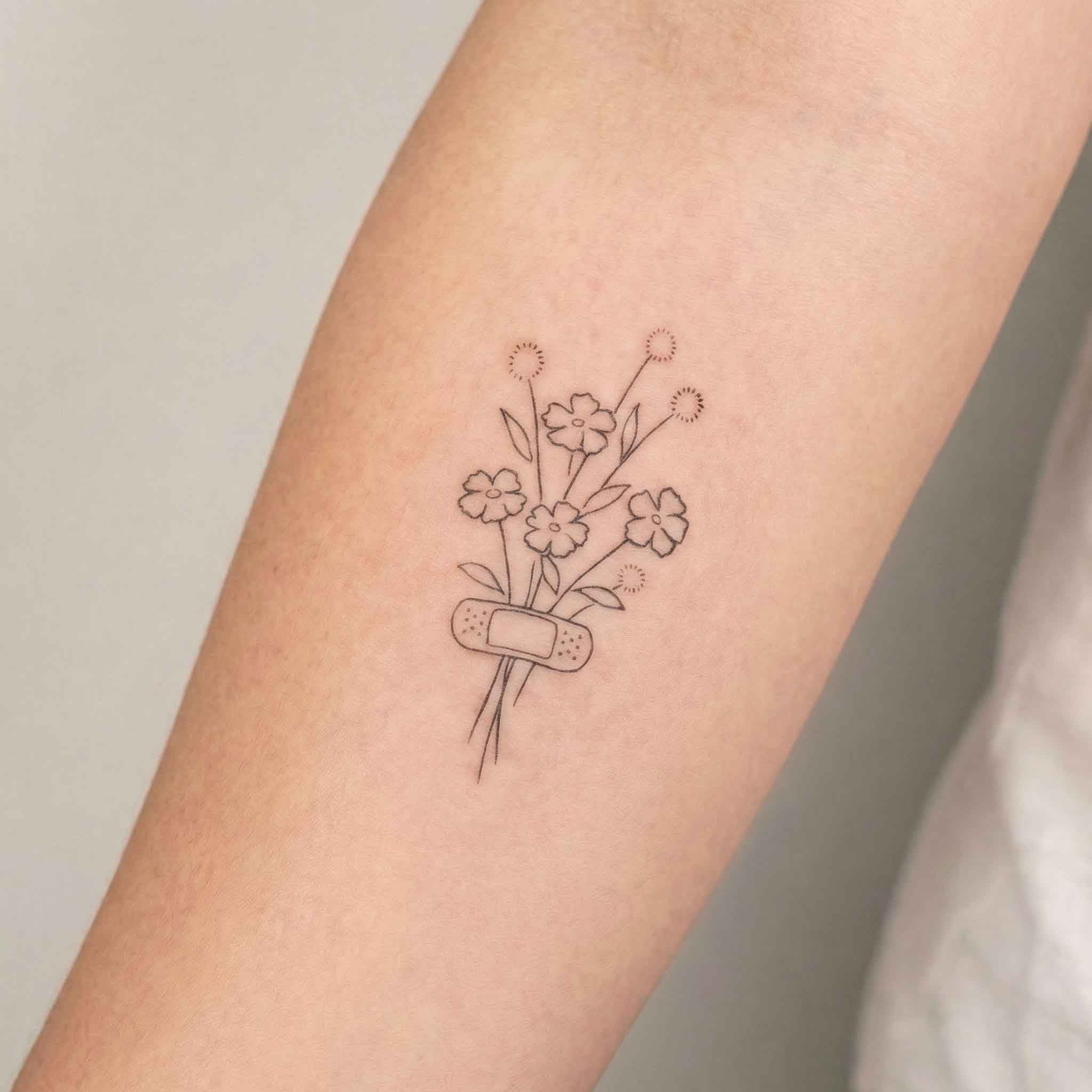 Small flower temporary tattoos worn on skin with a soft natural look